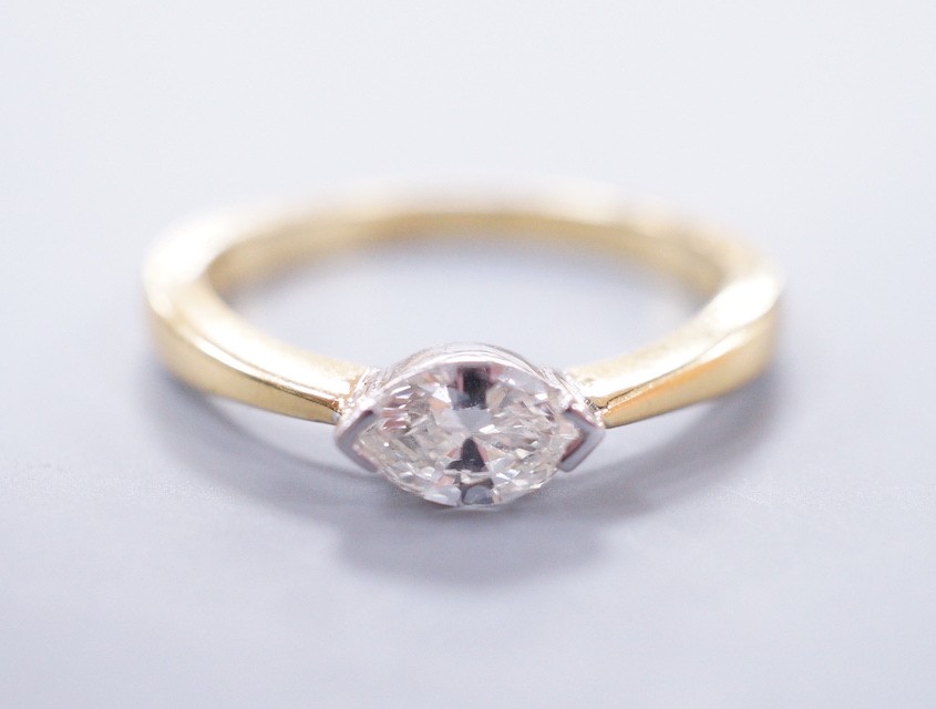 A modern 18ct gold and solitaire marquise cut diamond set ring, size L, gross weight 3 grams